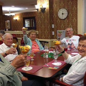 members toasting in dining room